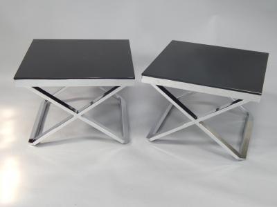 A pair of steel and blackened glass occasional tables