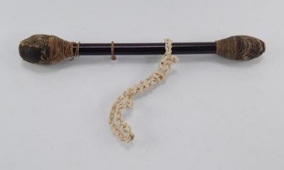 A hardwood and rope twist double ended drum beater.