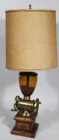 A brass hardwood and glass coffee grinder table lamp