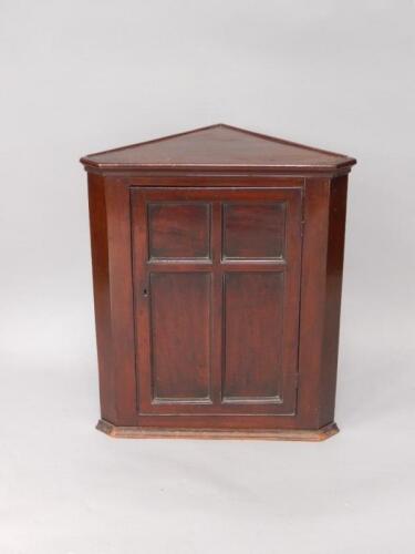 A Victorian mahogany wall mounted corner cupboard