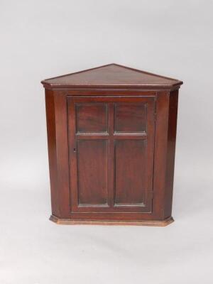 A Victorian mahogany wall mounted corner cupboard