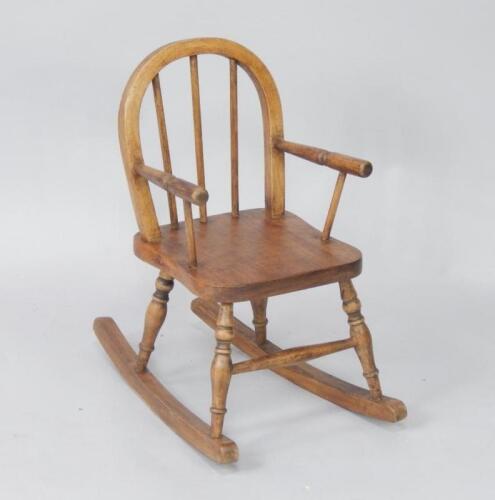 A child's oak spindle back rocking chair.