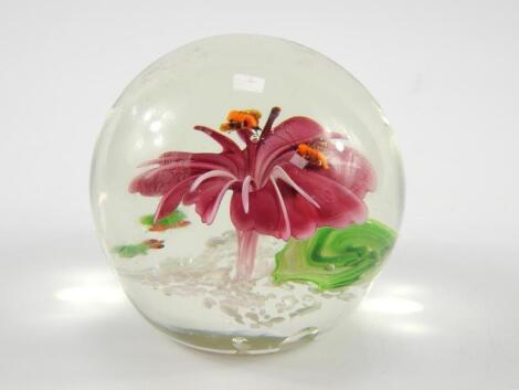 A Chinese glass paperweight modelled with an open flower