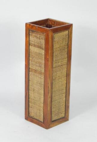 A hardwood and rattan square stick stand