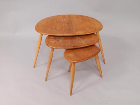 An Ercol nest of beech and elm kidney shaped occasional tables