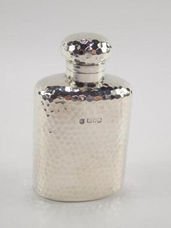 An Edward VII silver hip flask with hammered decoration