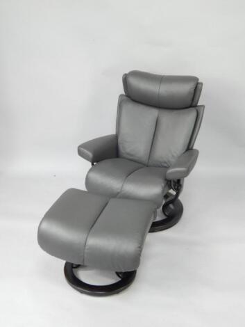 An EXO Stressless Magic large black leather armchair