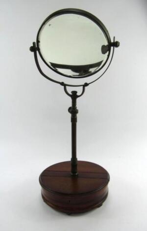 An Edwardian mahogany and brass shaving mirror