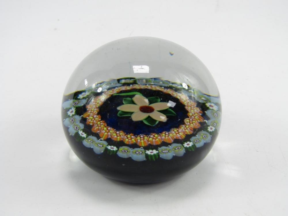 A Paul Ysart mid 20thC floral and concentric millefiori paperweight