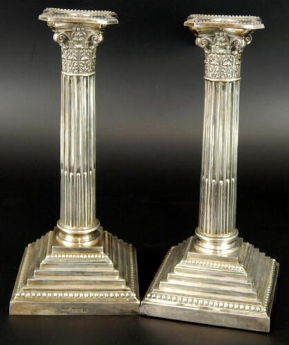 A pair of George V silver Corinthian column table candlesticks