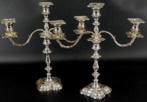 A pair of Elizabeth II silver three branch candelabra