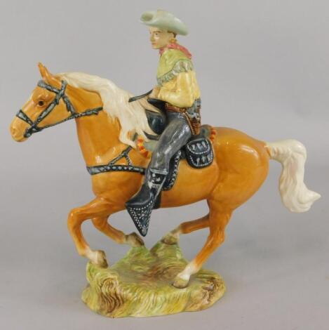 A Beswick ceramic model of a cowboy riding a palomino