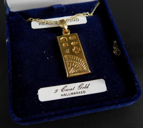 A 9ct gold ingot pendant and chain