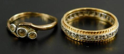 An 18 carat gold and white metal eternity ring