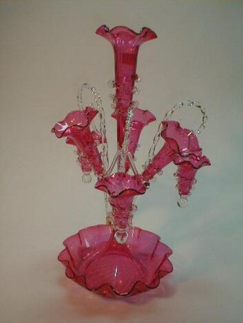 A modern cranberry glass epergne with three trumpets and three barley twist