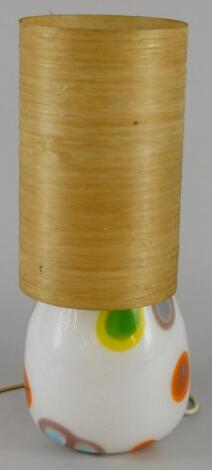 A retro style white opaque and coloured lamp base