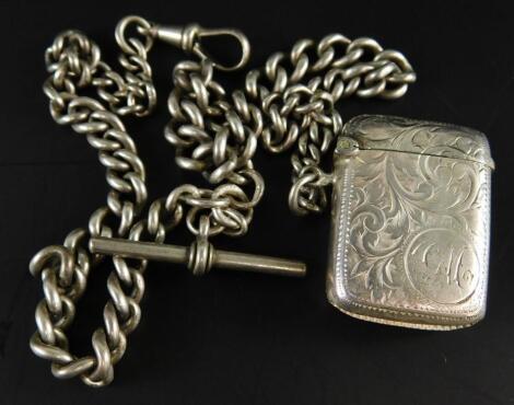 An Edwardian engraved silver vesta case and silver watch chain