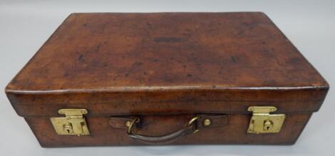 An early 20thC brown leather suitcase