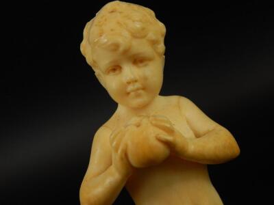 An early 20thC ivory figure of a young boy holding an apple - 4