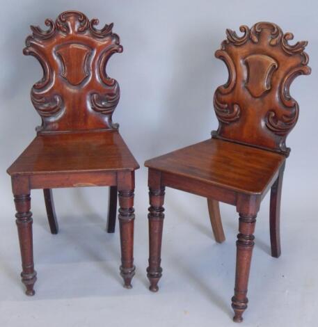 A pair of Victorian mahogany hall chairs