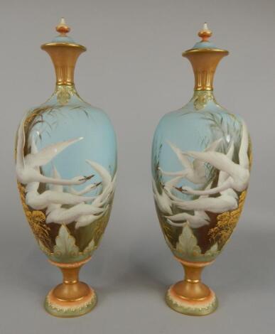 A pair of Royal Worcester vases and covers