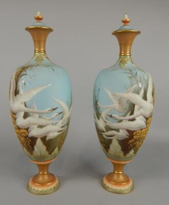 A pair of Royal Worcester vases and covers