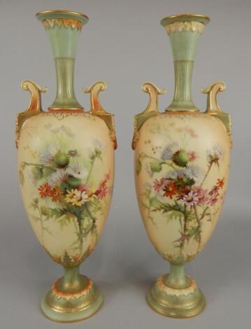 A pair of Royal Worcester two handled ovoid vases