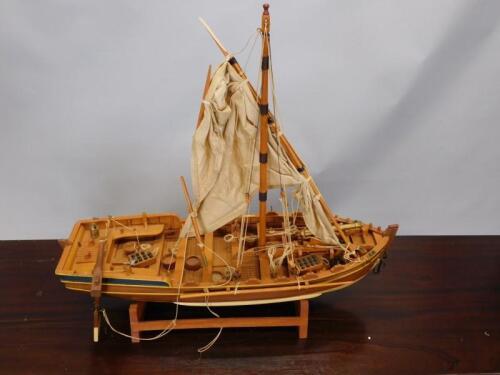 A scale model of a single masted sailing ship