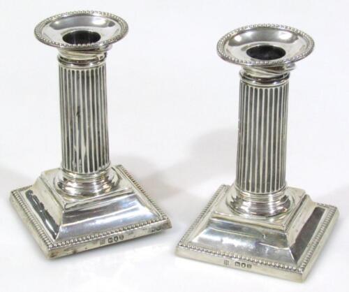 A pair of Victorian silver squat candlesticks