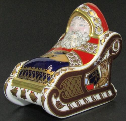 A Royal Crown Derby Santa Claus in a sleigh paperweight