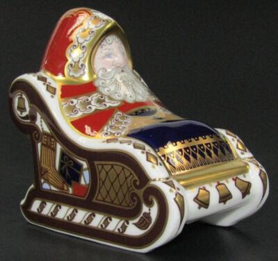 A Royal Crown Derby Santa Claus in a sleigh paperweight