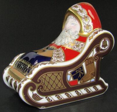 A Royal Crown Derby Santa Claus in a sleigh paperweight