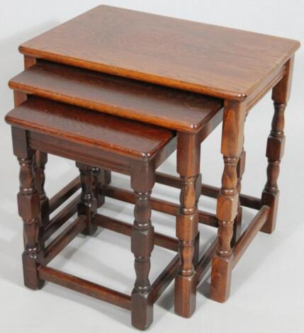 A nest of three oak tables.