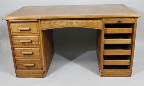 A 1930's oak twin pedestal office desk