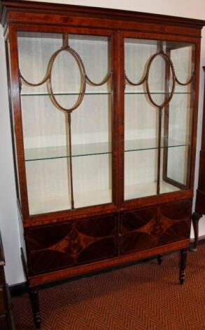 An Edwardian flame mahogany and boxwood strung double door display cabinet