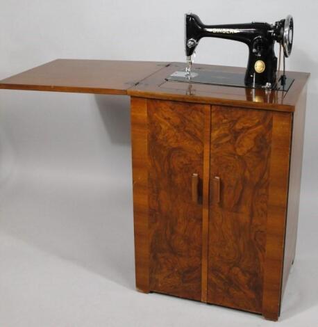 An early to mid 20thC walnut cased sewing cabinet