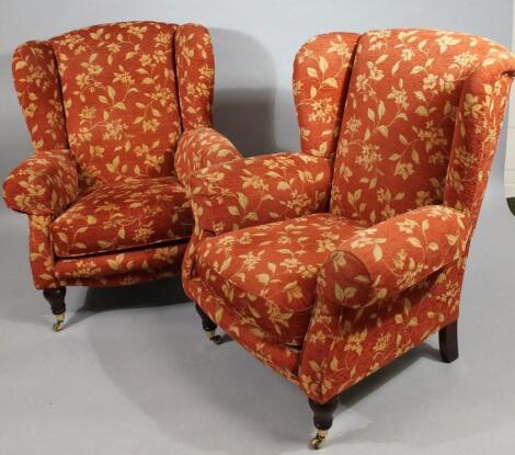 A pair of modern wing back armchairs