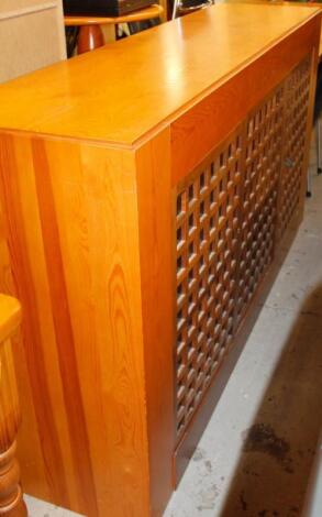 A modern pine finish sideboard