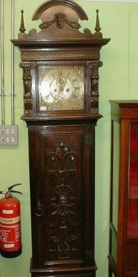 A carved oak longcase clock with brass dial inscribed W. Sellers