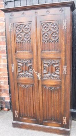 A 20thC Carolean style oak hall wardrobe