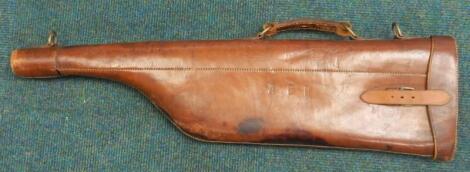 A brown leather leg of mutton gun case