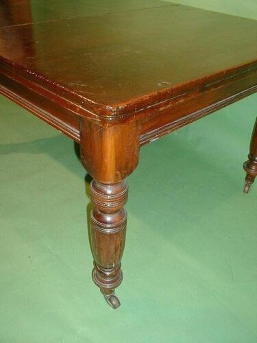 A Victorian wind-out dining table with two extra leaves and fluted legs