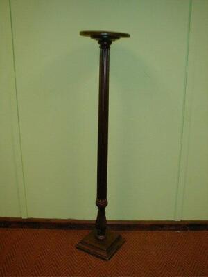 A reeded mahogany torchere stand