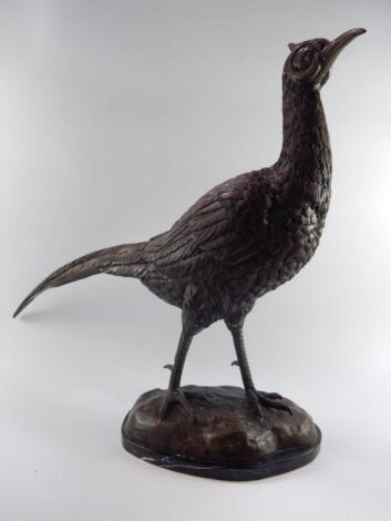 A bronze figure of a standing pheasant