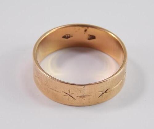 A wedding band with engraved decoration