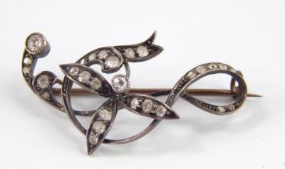 A 19thC diamond set scrolling floral brooch