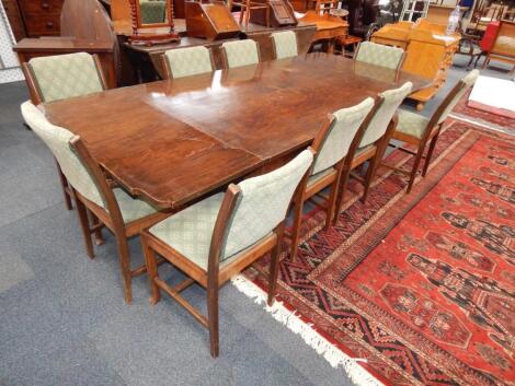 An Art Deco walnut draw leaf dining table