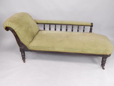 A Victorian ebonised chaise longue