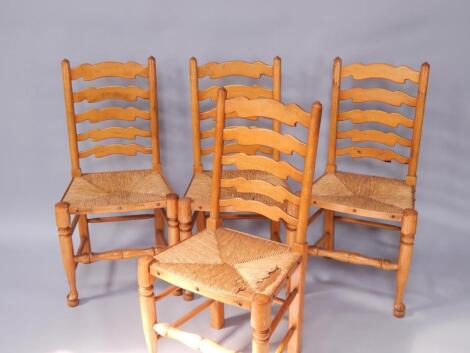 A set of four light oak ladderback single dining chairs