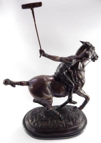 A bronze coated figure of a polo player